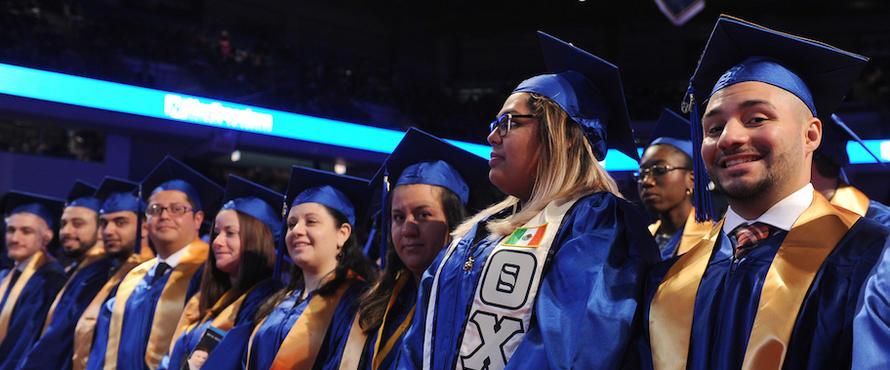 Students smile during Commencement.