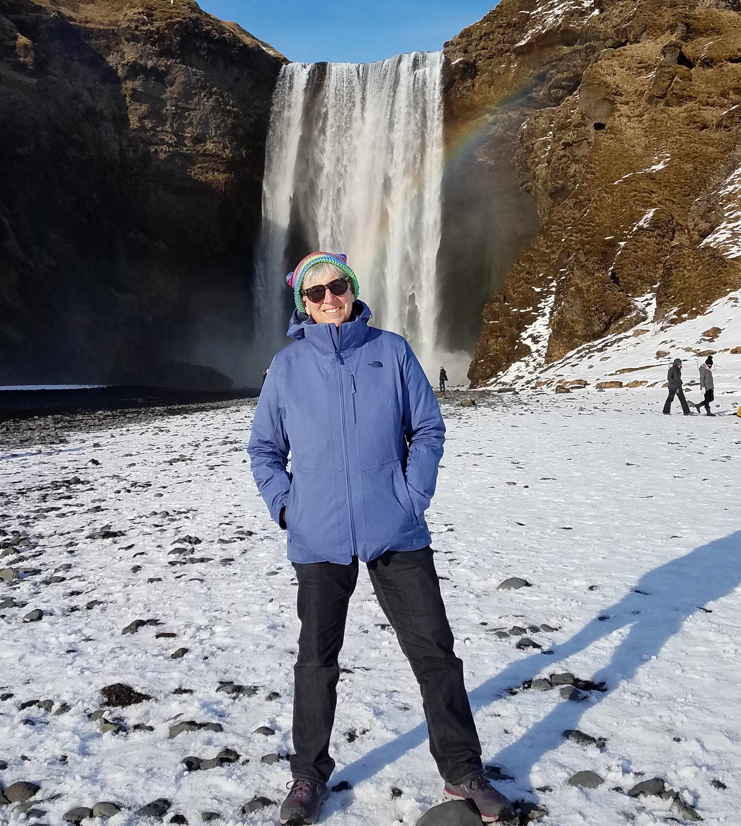 "Laura in front of a water fall standing on snow"