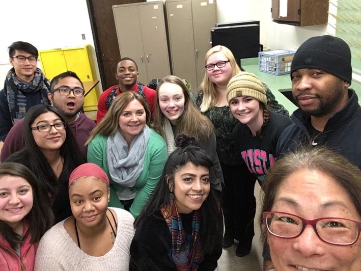 "Maureen and students in a classroom selfie "