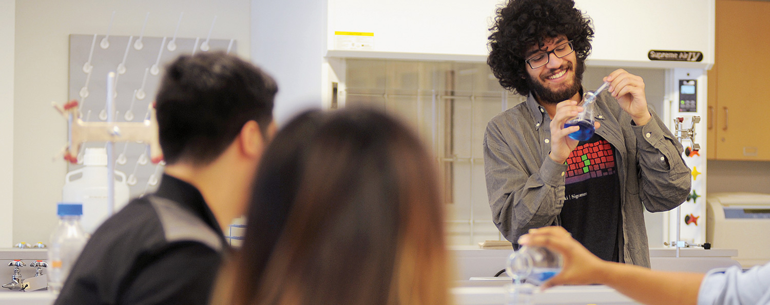 NEIU students performing an experiment in a science lab