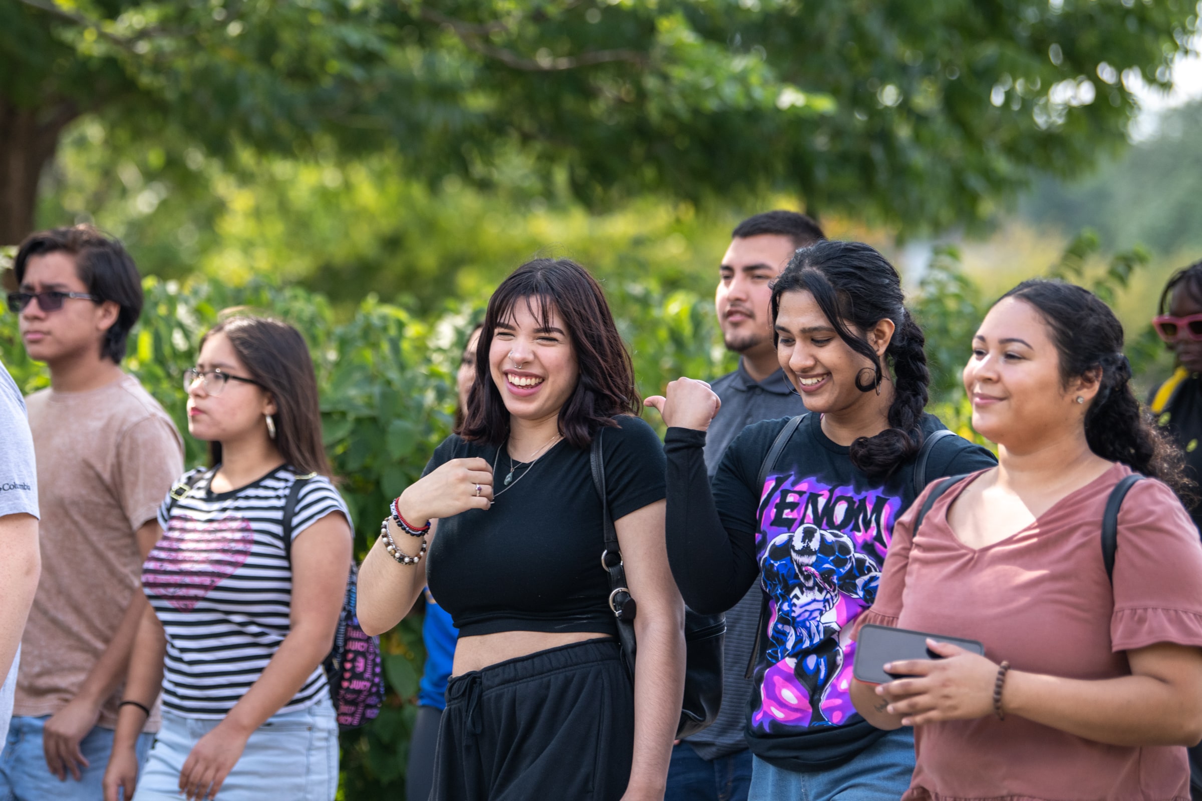 A group of students walk outdoors through Northeastern Illinois University's campus