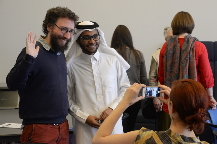 two people standing side by side and smiling at a camera