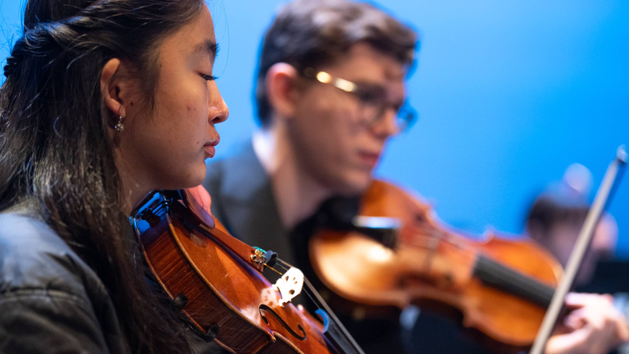 Two violinists performing