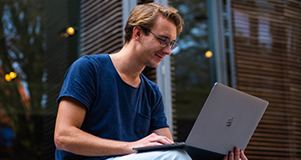 A student using a laptop.