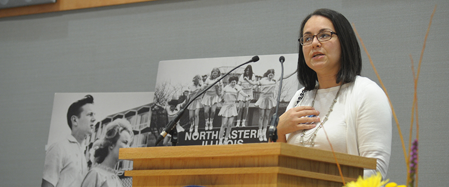 Speaker at podium presenting at Alumni Reunion 2013.