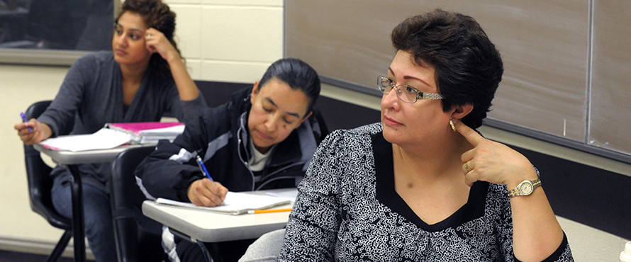 Three female students in a classroom setting