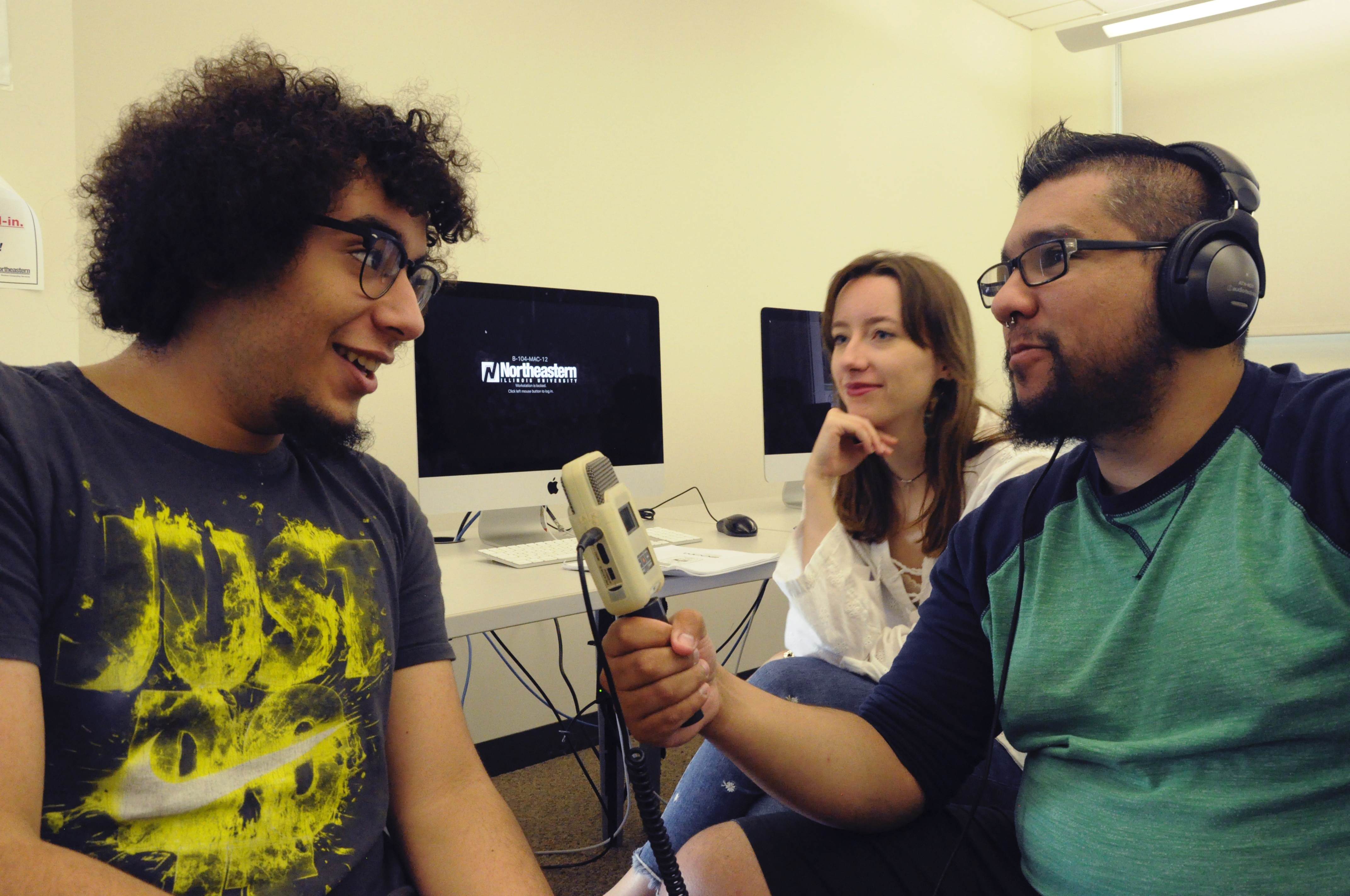 Journalism students speak to each other in class.