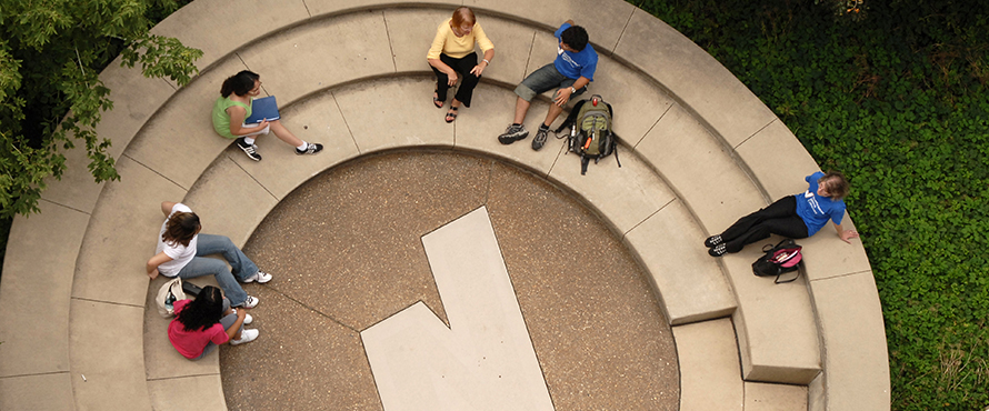 People sitting near NEIU logo