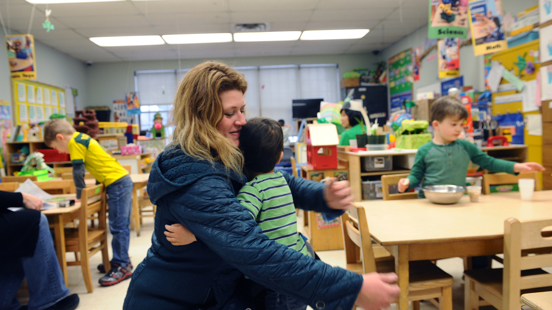Woman hugging child in the Child Care Center