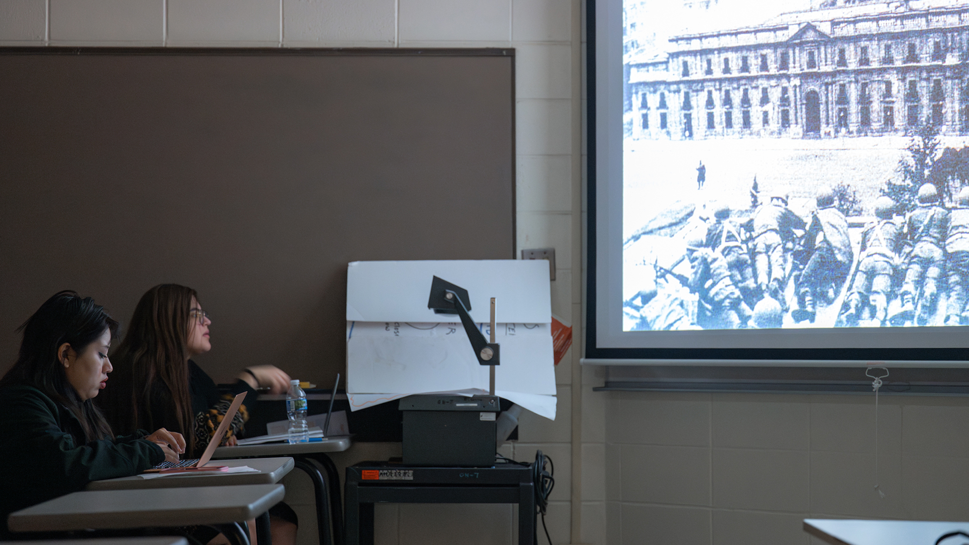 Two students engaged in a lecture.