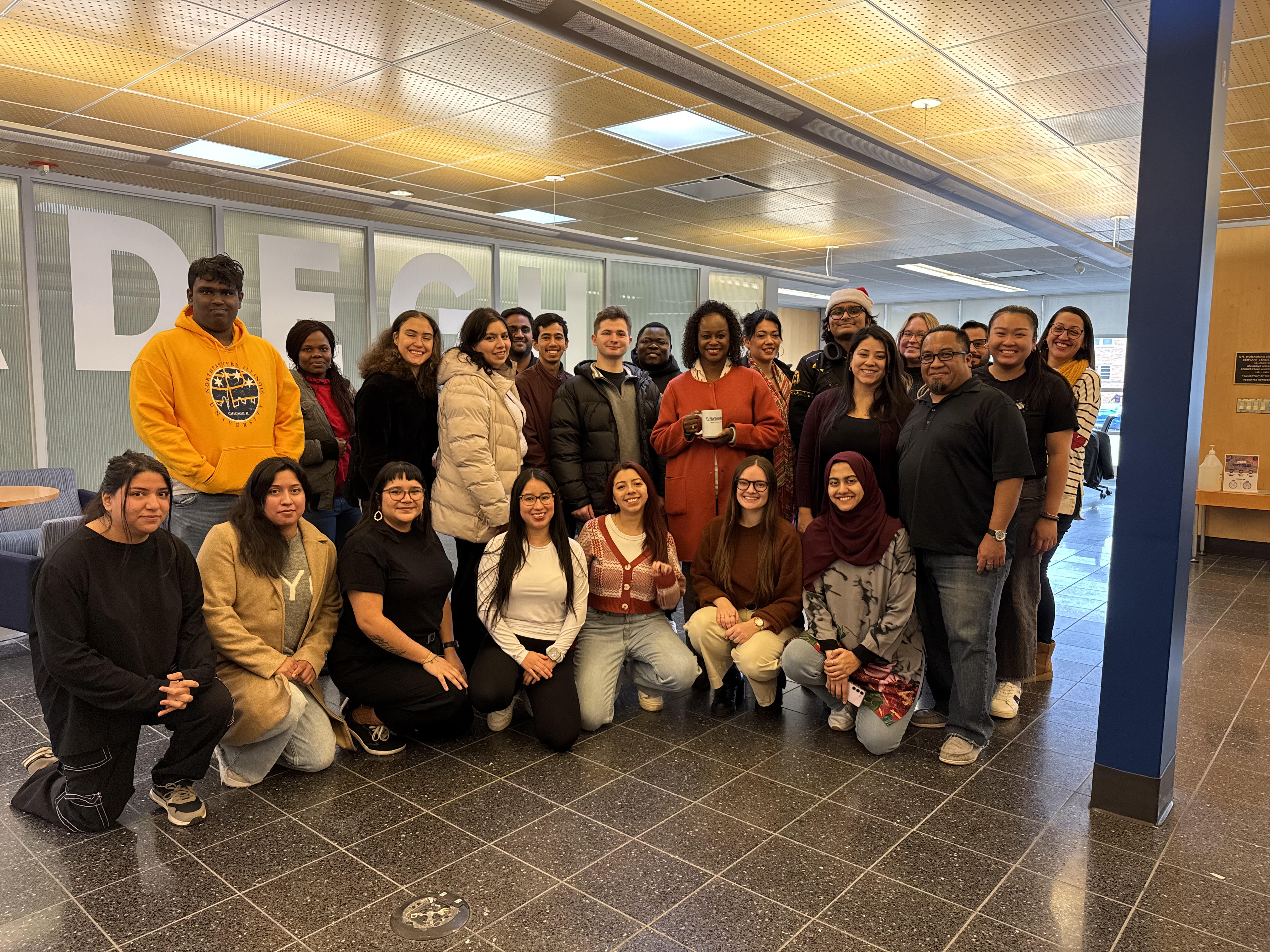 Students pose for a picture with NEIU President Dr. Bell-Jordan in the Mossadegh Hall