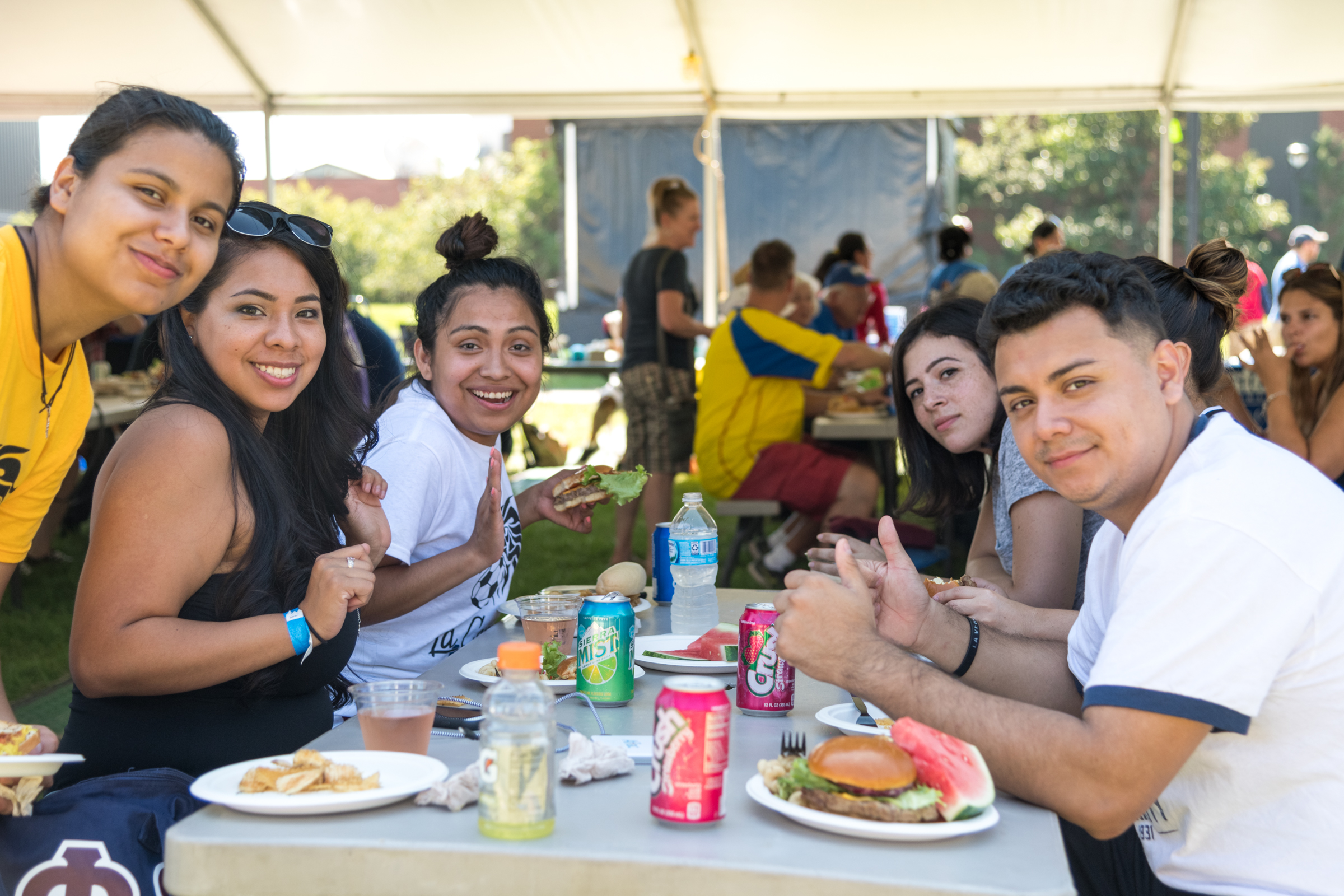 Students gathered outside around a table.