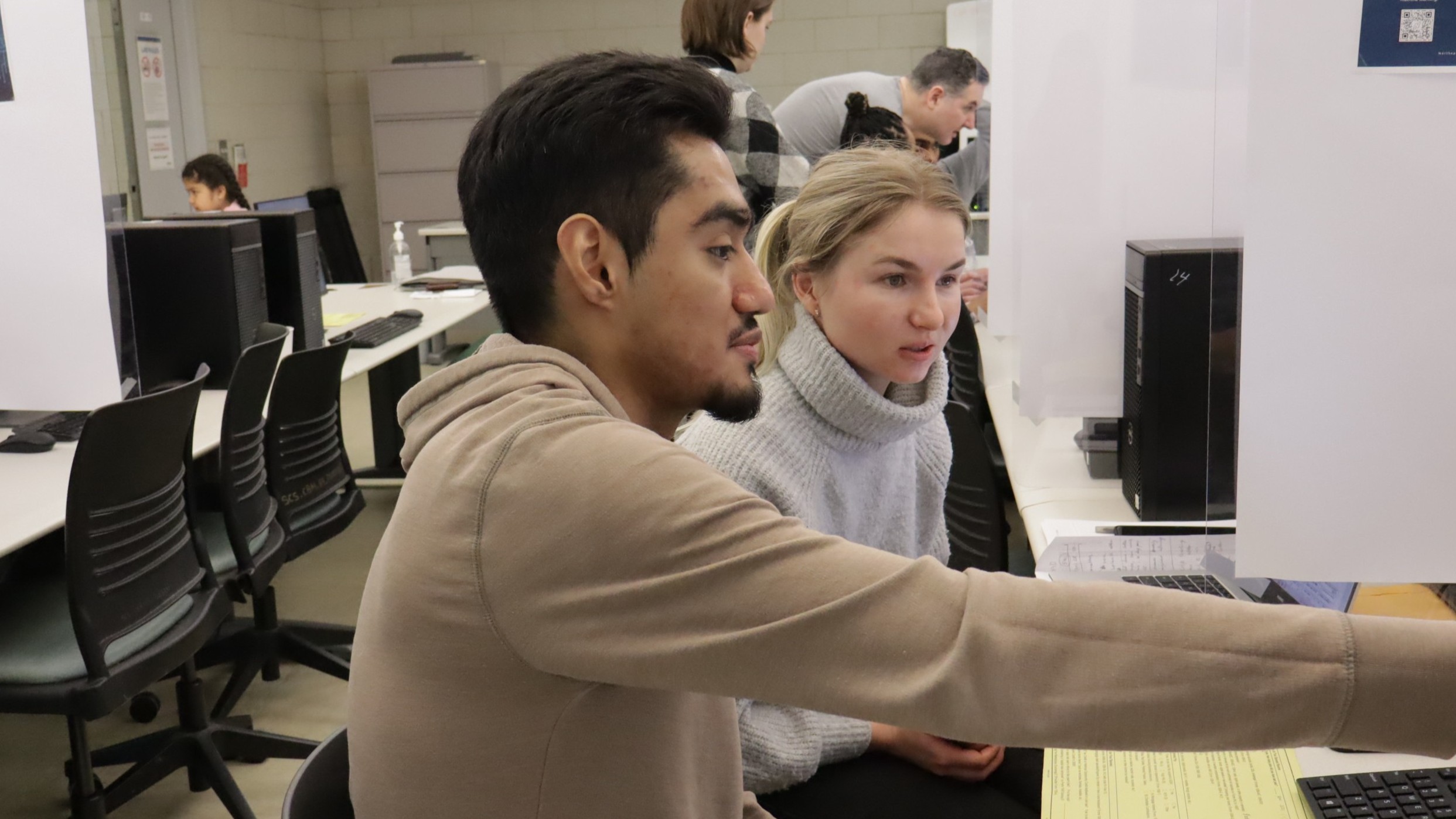 A student helps another student during the VITA program 