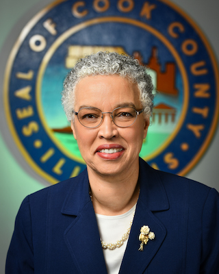 Toni Preckwinkle with the Seal of Cook County in the background.