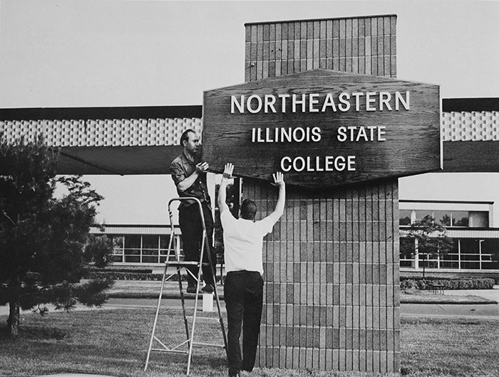 Workers prepare the sign for Northeastern Illinois State College in 1967.
