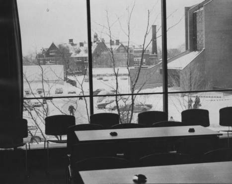 The view from the Commuter Center is shown on a snowy day in the late 1970s. This south-facing view shows the library and a parking lot that is now the University Commons.