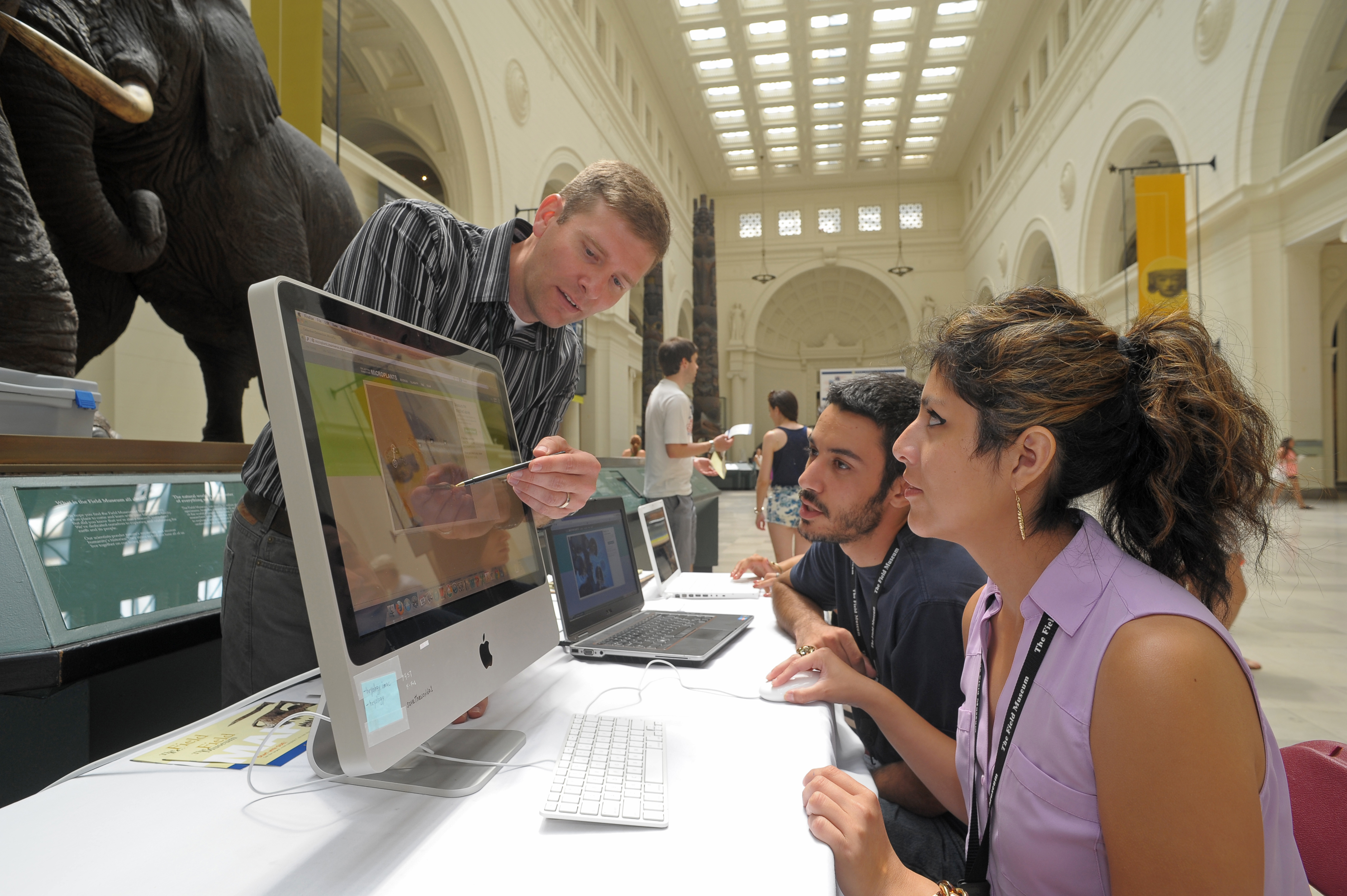 Northeastern biology instructor Tom Campbell works with students last summer at the Field Museum.