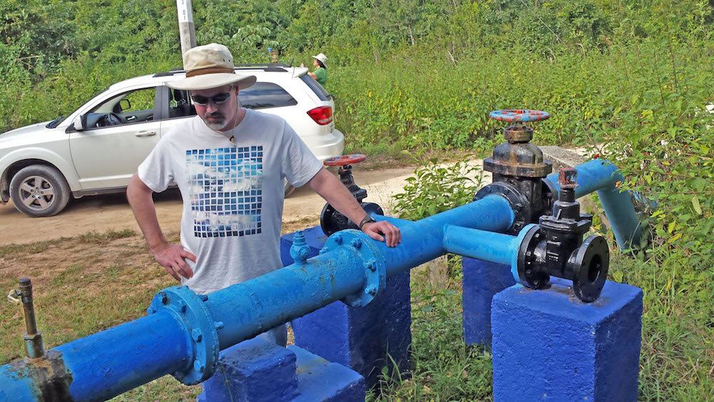Earth Science Department Coordinator Ken Voglesonger examines one of the pumps that supply groundwater to the city.