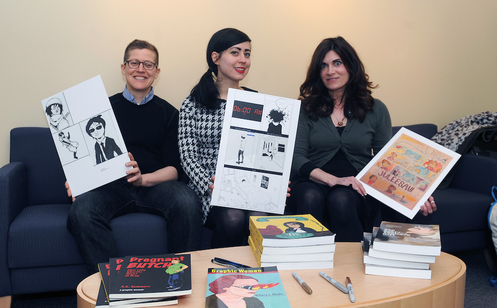 Graphic novelists (from left) A.K. Summers, Nicole Georges and Phoebe Gloeckner hold up student art before their Visiting Writers Series event on March 24.