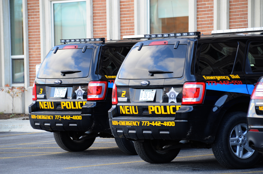 Two parked NEIU Police Department vehicles