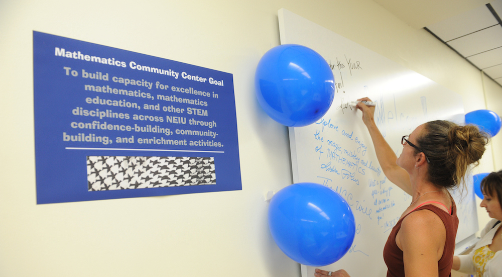 A woman writes on the writeboard in the new Mathematics Community Center