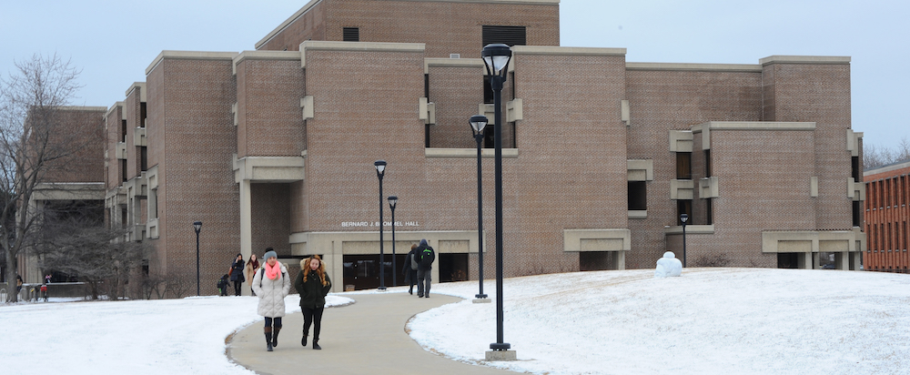 Students walk across the Commons in winter