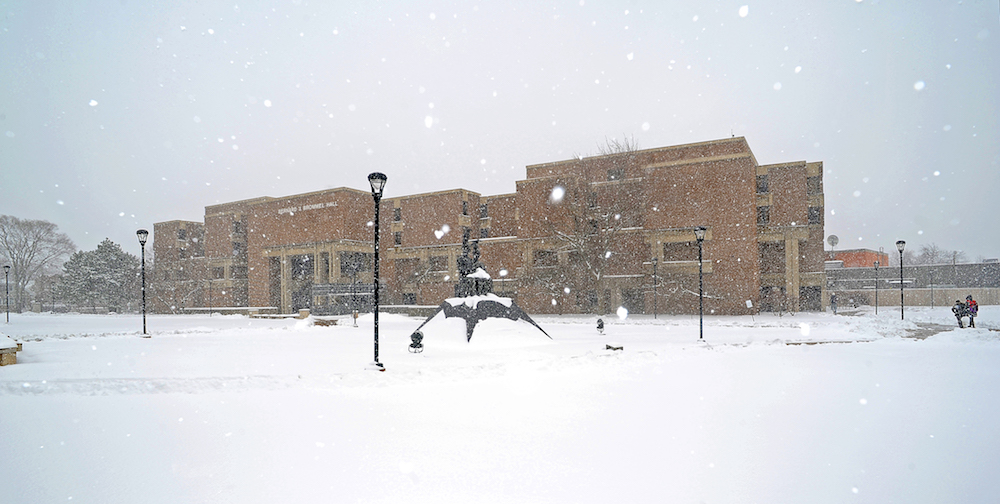 Snow falls on the Commons at Northeastern Illinois University.