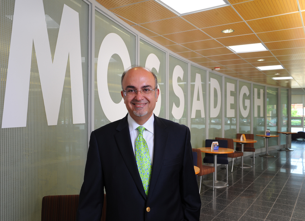 Dr. Mateo Farzaneh stand in the Mossadegh Servant Leaders Hall in the College of Busines and Management Building