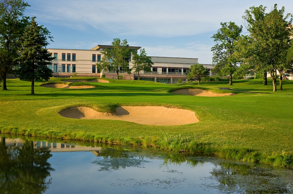 A golf course sandtrap at the Eaglewood Resort & Spa in the foreground and the resort's building in the background