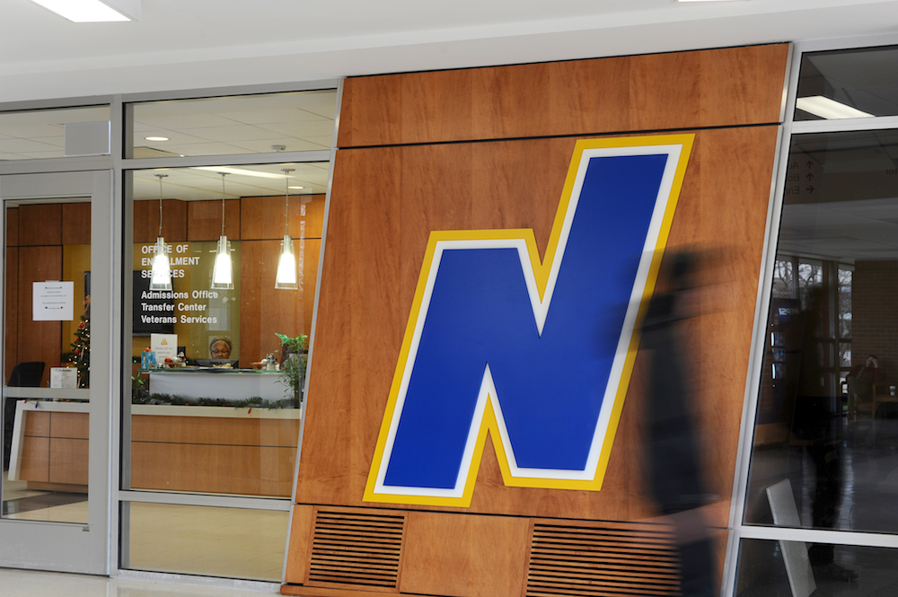 Northeastern's Flying N logo at the entrance of the Office of Enrollment Services