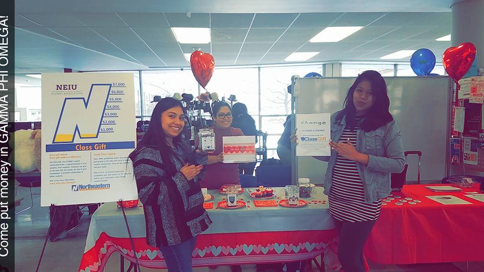 Three students smile for the camera at All Is Fair In Love and Penny Wars.