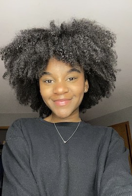 A photo of Asha Brown wearing a Black shirt looking directly into the camera.