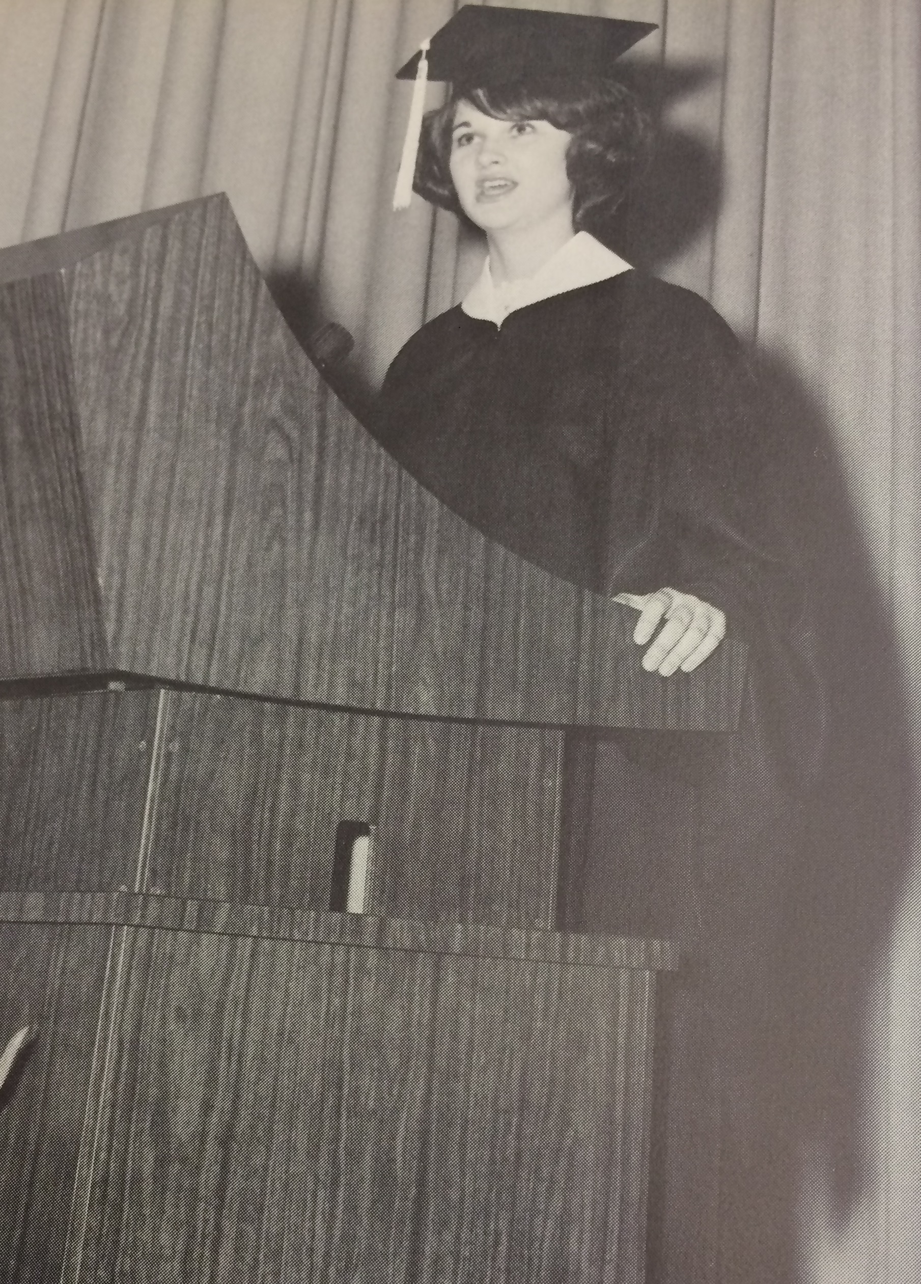 A female graduate at a lectern