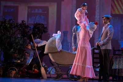 A photo of Suárez Ruiz's daughter holding up Suárez Ruiz's granddaugher during a performance of “Madrileño.” 
