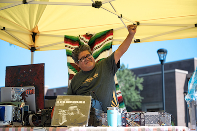 A man raises his arm outdoors