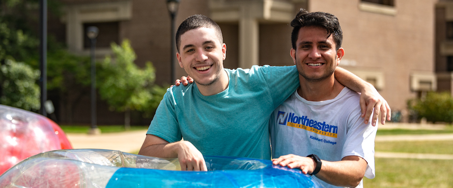 A photo of two students after a bubble soccer match on the University Commons