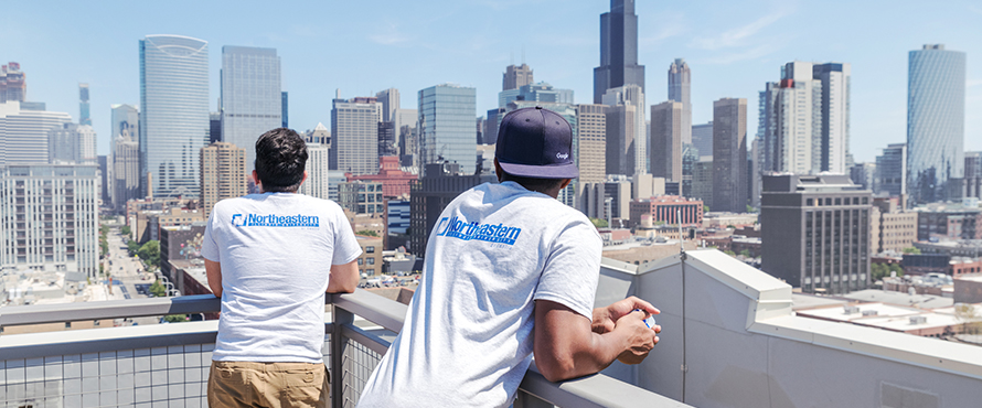 Male students looking out over the city of Chicago