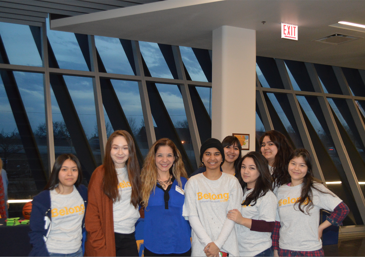 Group photo of students and Denise in their gray NEIU belong shirt