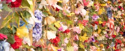 A wall covered in flowers and greenery