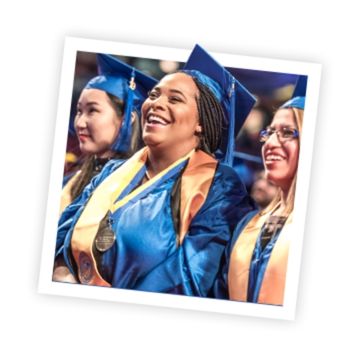 Three NEIU graduates in commencement robes and caps