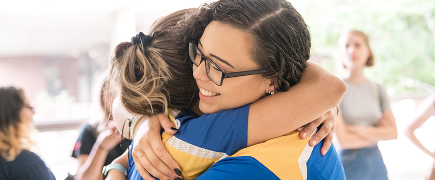 Two female students hugging
