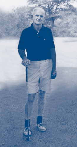 Portrait of Chuck Kane holding a golf club.
