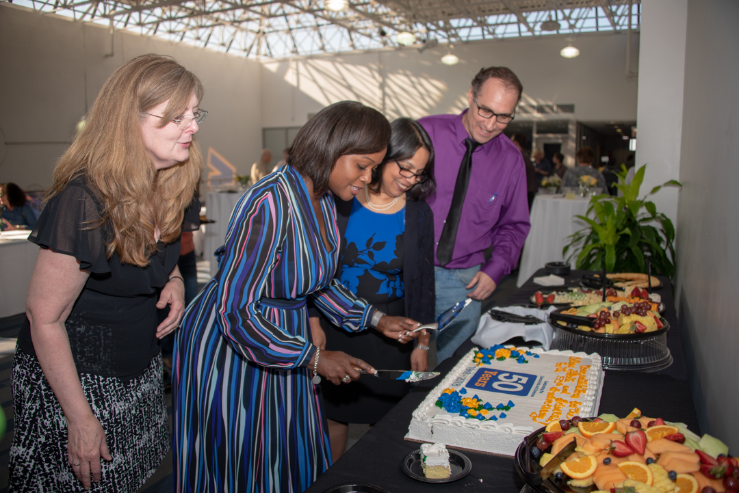CAS 50 Year Anniversary - dean cutting the cake