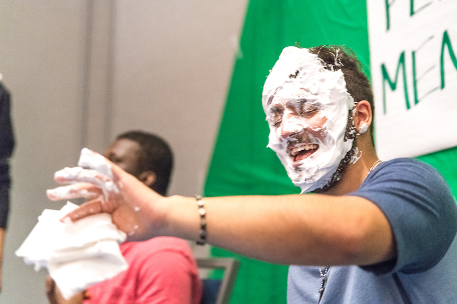 FYE Peer Mentor laughing with face covered in shaving cream after being pied