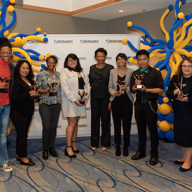 A photo of President’s Inclusive Excellence and Diversity Award recipients holding their awards with President Gloria J. Gibson (center)  