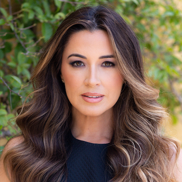 A headshot photo of Alejandra Campoverdi wearing a black shirt, facing the camera, against a green leaf background.