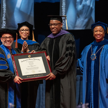 University administrators present Kwame Raoul with an honorary doctor of humane letters