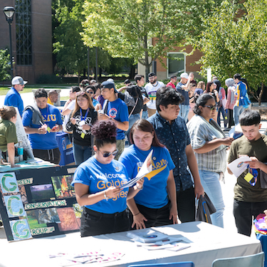 Students gather outdoors during Golden Eagle Welcome Day