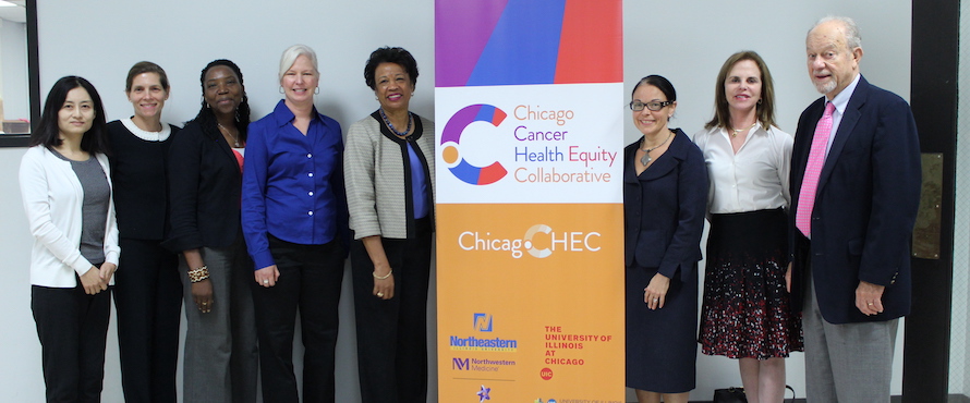 A photo of people standing near a ChicagoCHEC banner at a pre-COVID-19 event.
