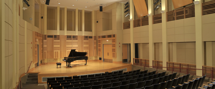 Photo of NEIU's Recital Hall with a piano on the stage